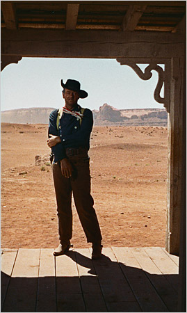 John Wayne standing in a doorway shot from John Ford's "The Searchers"