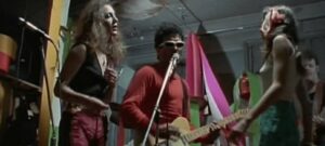 A still from the film showing The roosters rehearsing in the same apartment building Reno lives in.
